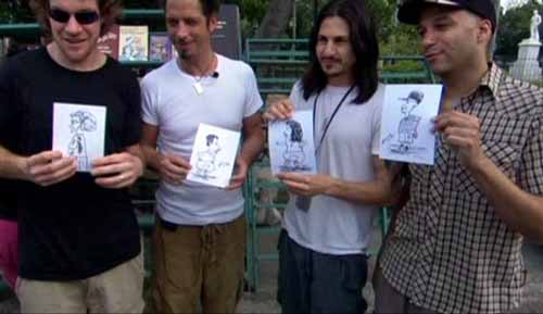 
Tim Commerford, Chris Cornell, Brad Wilk, and Tom Morello of Audioslave hold up caricatures in the Plaza de Armas in Old Havana Veija - Audioslave Live in Cuba DVD
